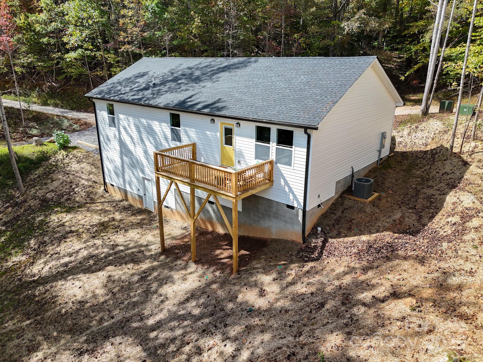 139 Burley Ridge Candler, NC 28715 - Photo 6 of 40 a roof deck with table and chairs under an umbrella with a dry yard