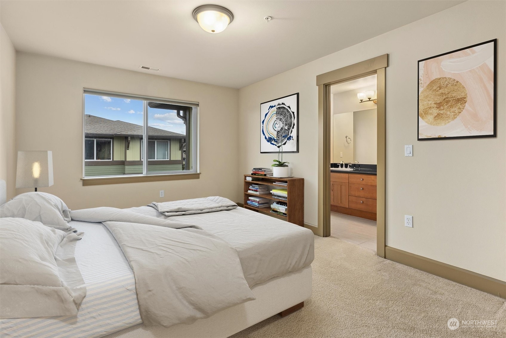 2115 201st Place Southeast, Unit I4 Bothell, WA 98012 - Photo 14 of 24 a bedroom with a bed and a painting on the wall