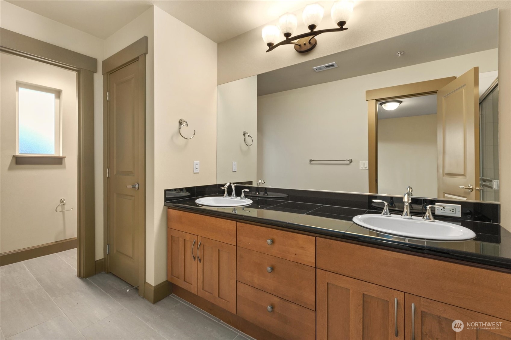 2115 201st Place Southeast, Unit I4 Bothell, WA 98012 - Photo 16 of 24 a bathroom with double sink and a mirror