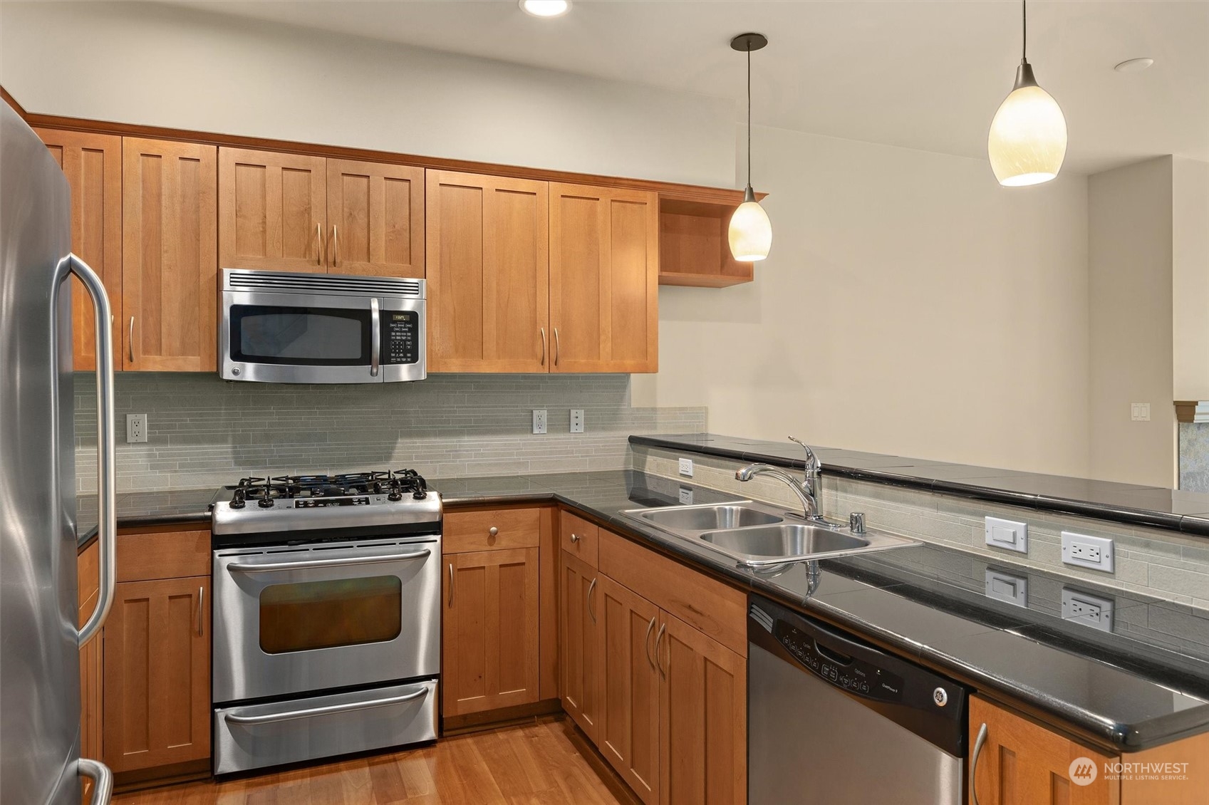 2115 201st Place Southeast, Unit I4 Bothell, WA 98012 - Photo 5 of 24 a kitchen with a sink stove and microwave