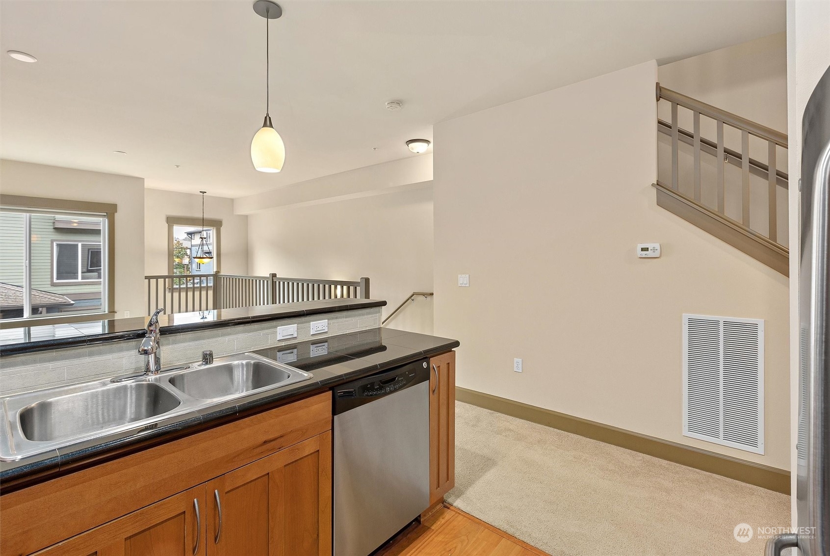 2115 201st Place Southeast, Unit I4 Bothell, WA 98012 - Photo 6 of 24 a kitchen with granite countertop a sink and a refrigerator