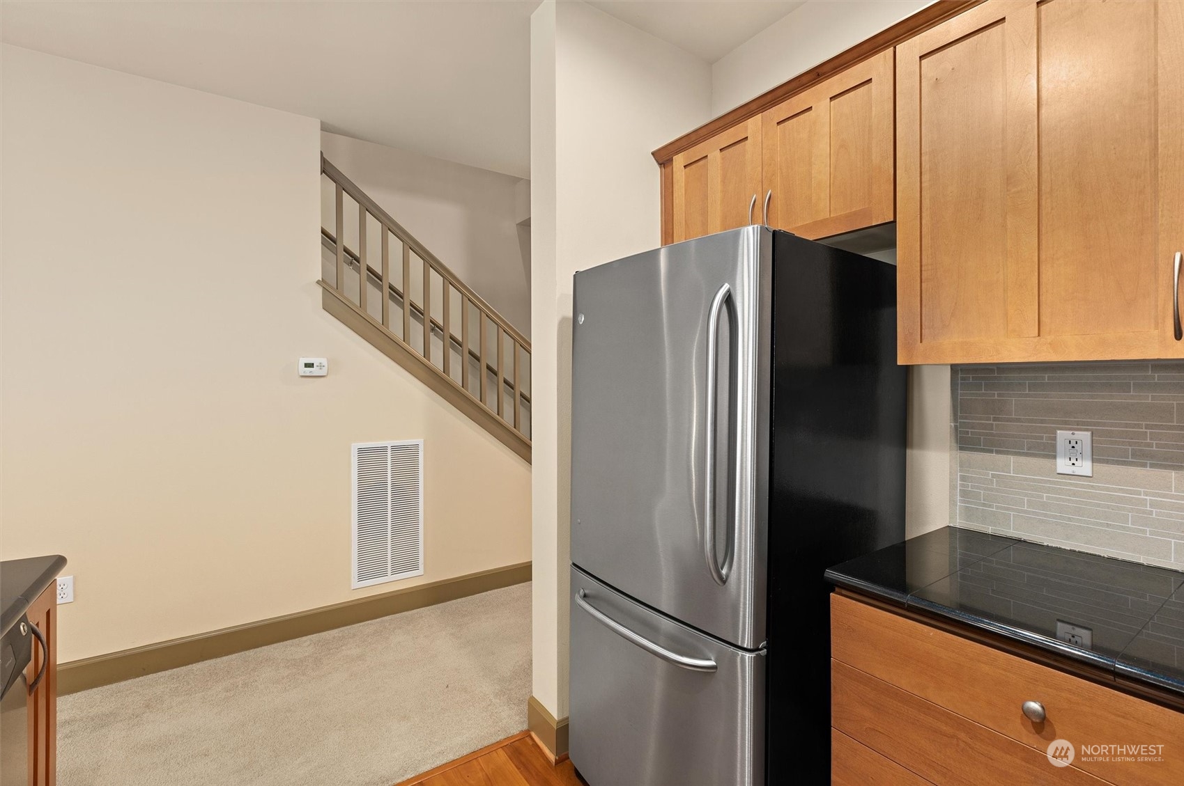 2115 201st Place Southeast, Unit I4 Bothell, WA 98012 - Photo 7 of 24 a kitchen with metallic refrigerator and cabinets