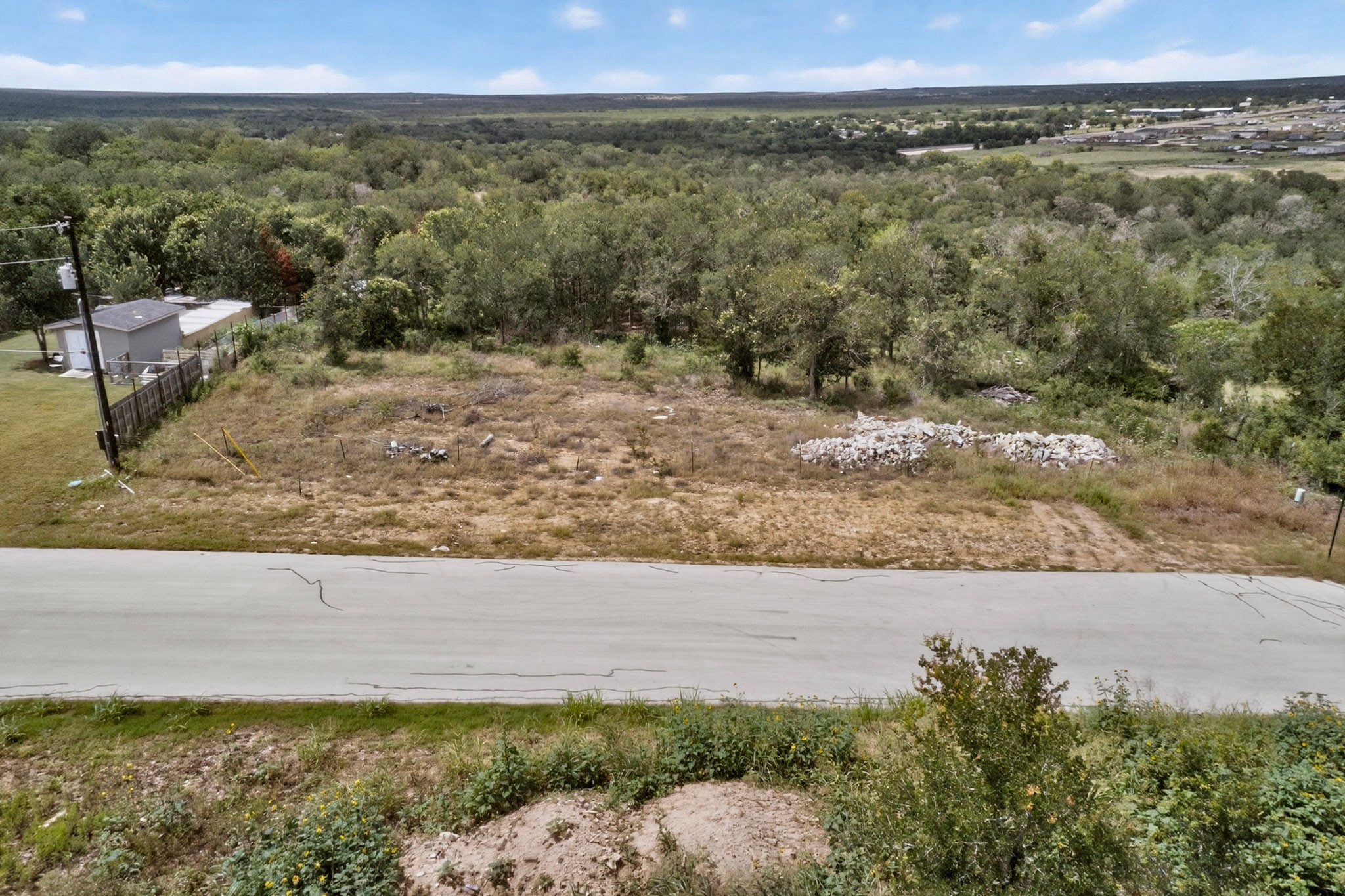 693 Santa Teresa Road Kyle, TX 78640 - Photo 14 of 20 A spacious lot provides a blank canvas for your dream home, surrounded by verdant trees and open skies.