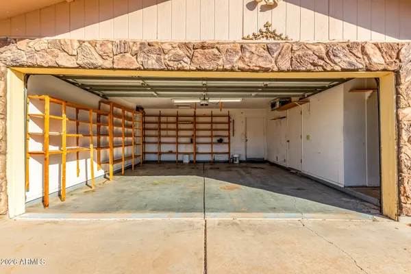 a view of a backyard with plants and a patio