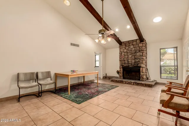 a living room with furniture a fireplace and a table