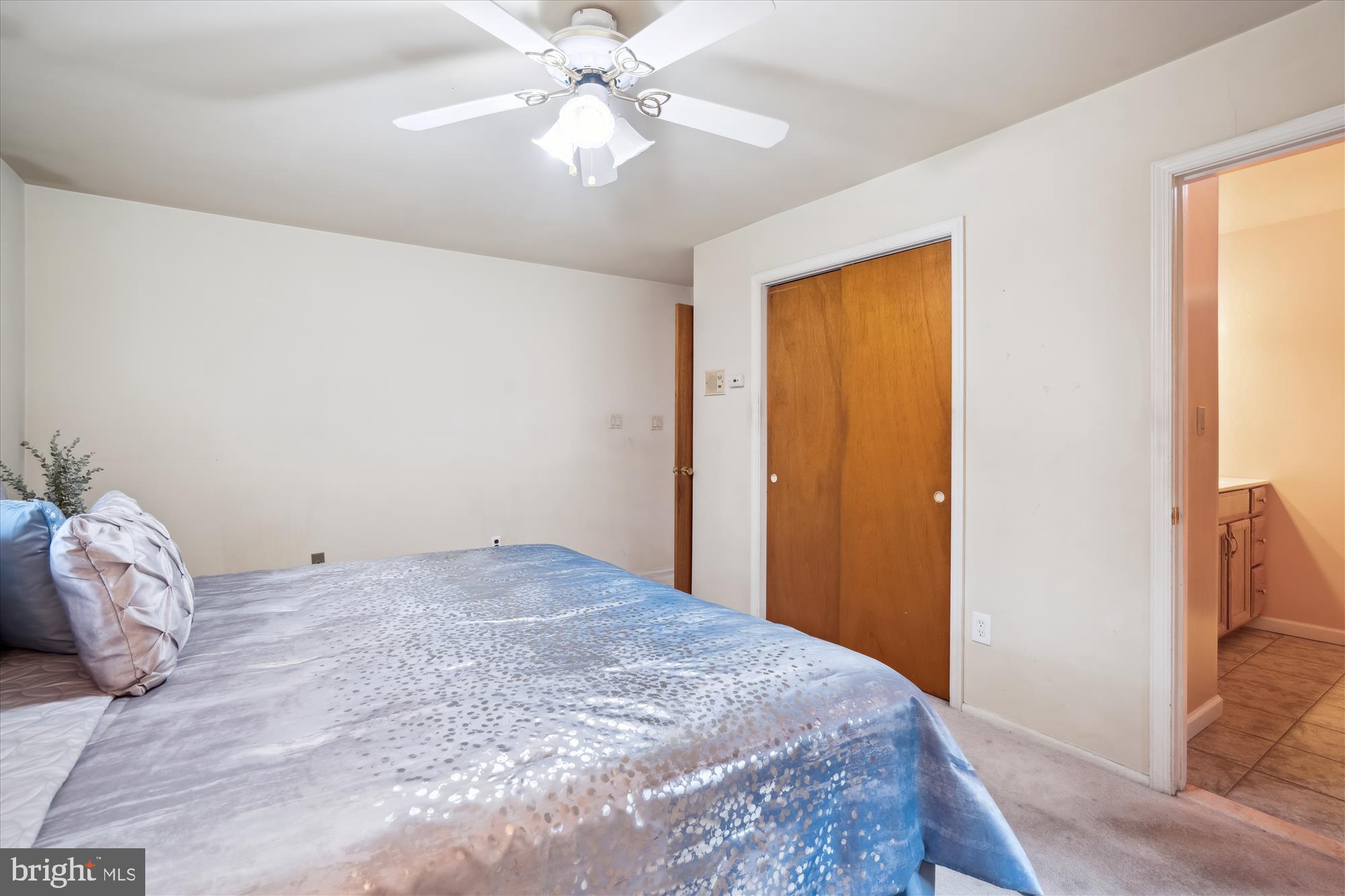 12103 Chesterton Drive Upper Marlboro, MD 20774 - Photo 30 of 30 a bedroom with a bed and a chandelier fan