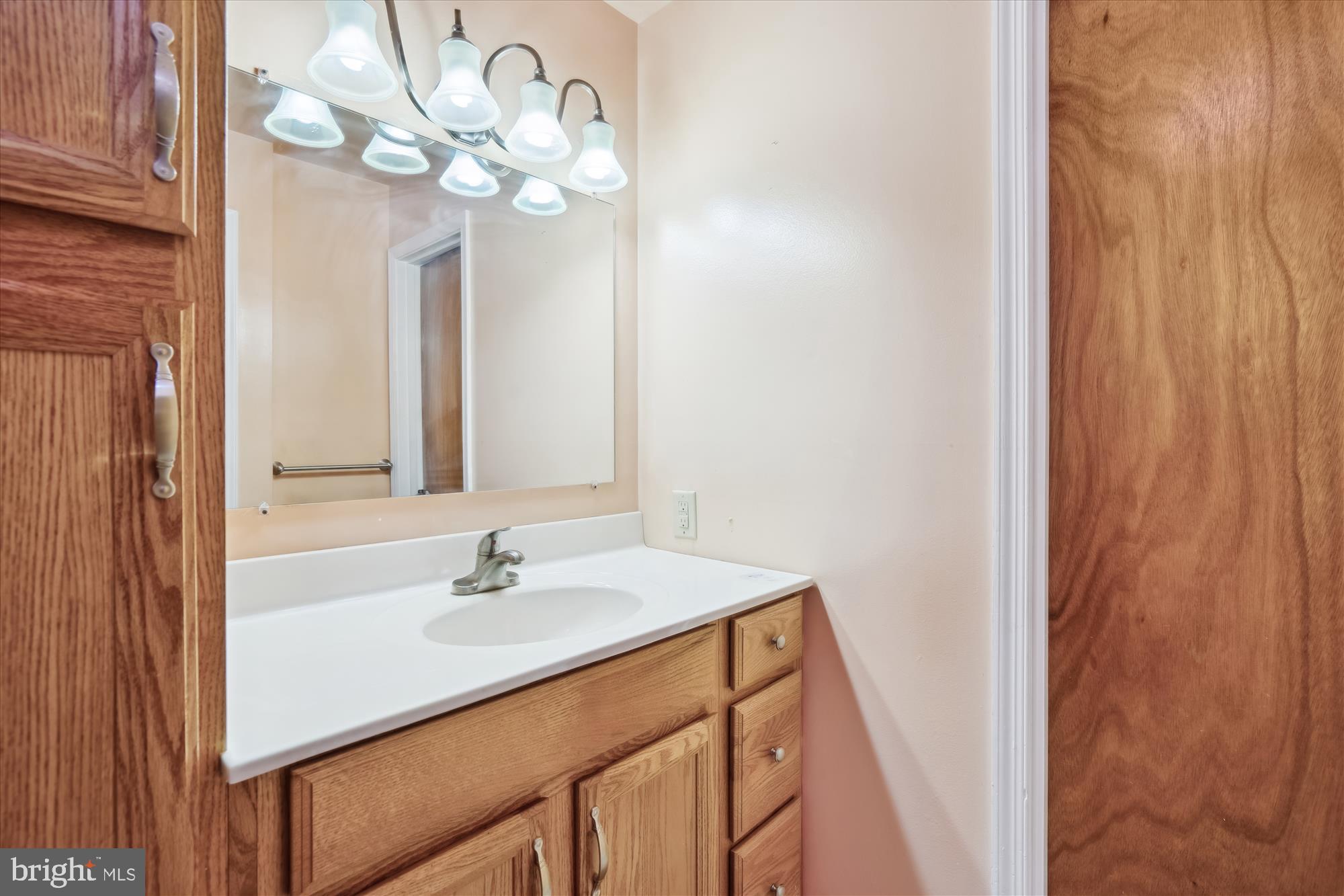 12103 Chesterton Drive Upper Marlboro, MD 20774 - Photo 4 of 30 a bathroom with a sink a mirror and a light fixture