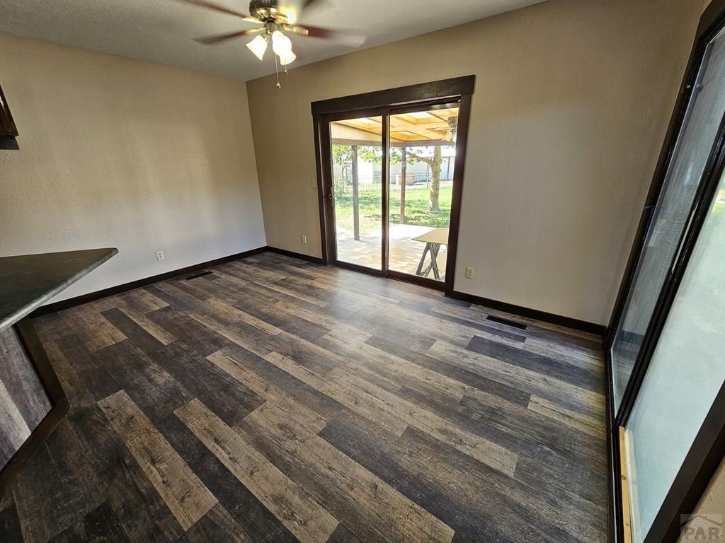 401 Park Street Springfield, CO 81073 - Photo 18 of 50 a view of an empty room with wooden floor and a window