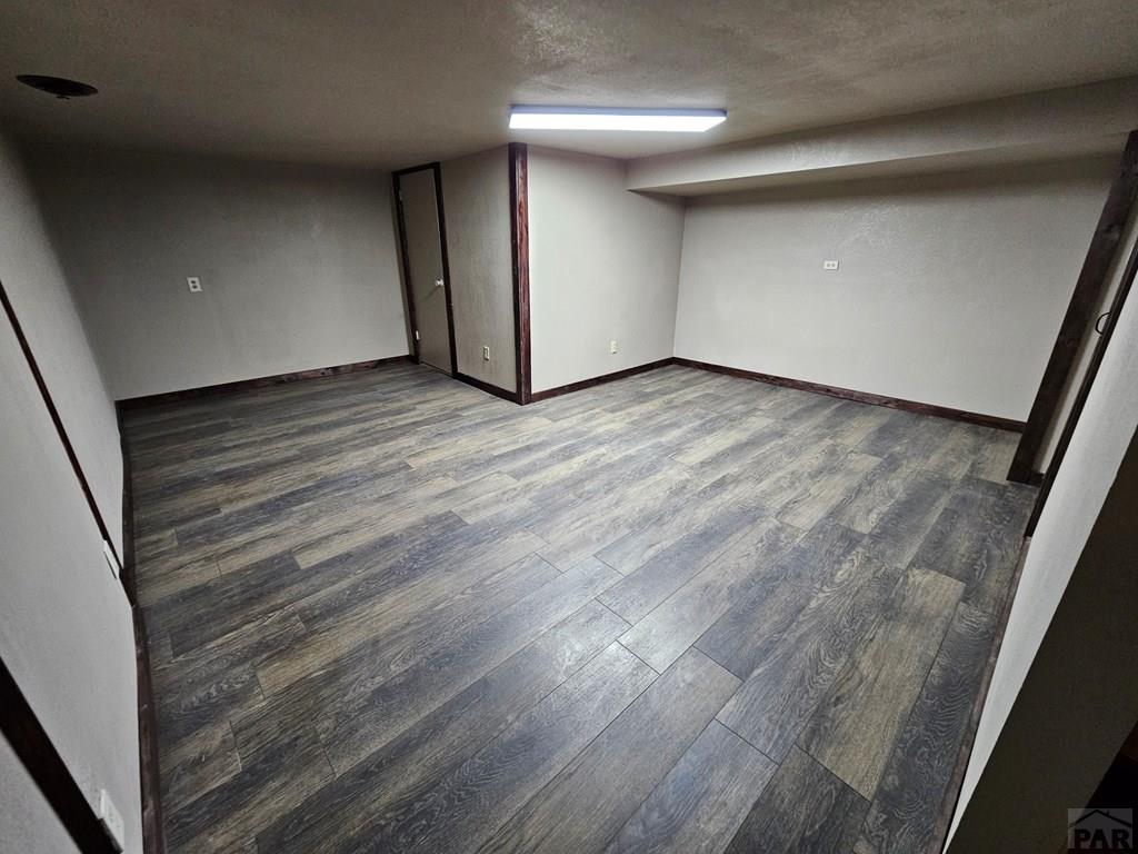 401 Park Street Springfield, CO 81073 - Photo 28 of 50 a view of an empty room with wooden floor and a window