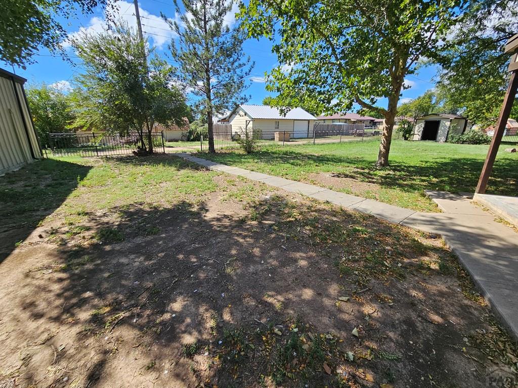 401 Park Street Springfield, CO 81073 - Photo 44 of 50 a view of a yard with plants and a tree