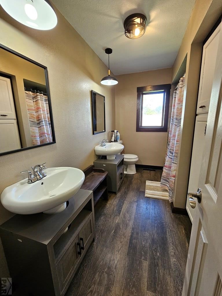 401 Park Street Springfield, CO 81073 - Photo 7 of 50 a bathroom with a sink mirror and wooden floor