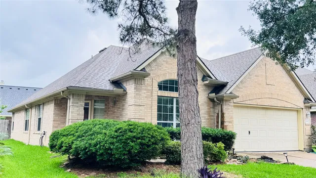 a view of a white house next to a yard