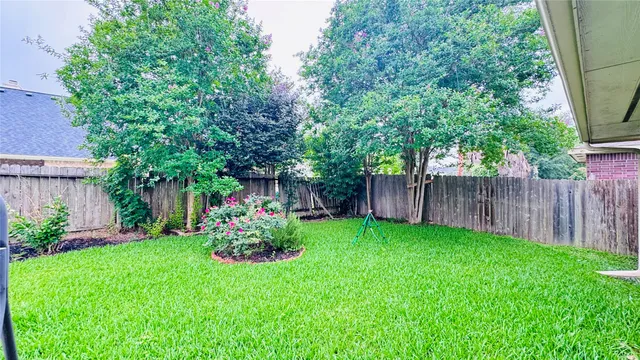 a green field covered with trees in the background