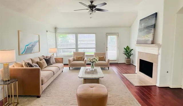 a living room with furniture fireplace and window