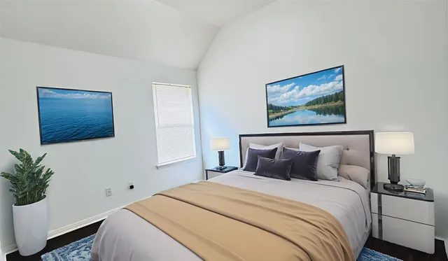 a bedroom with a bed and a painting on the wall