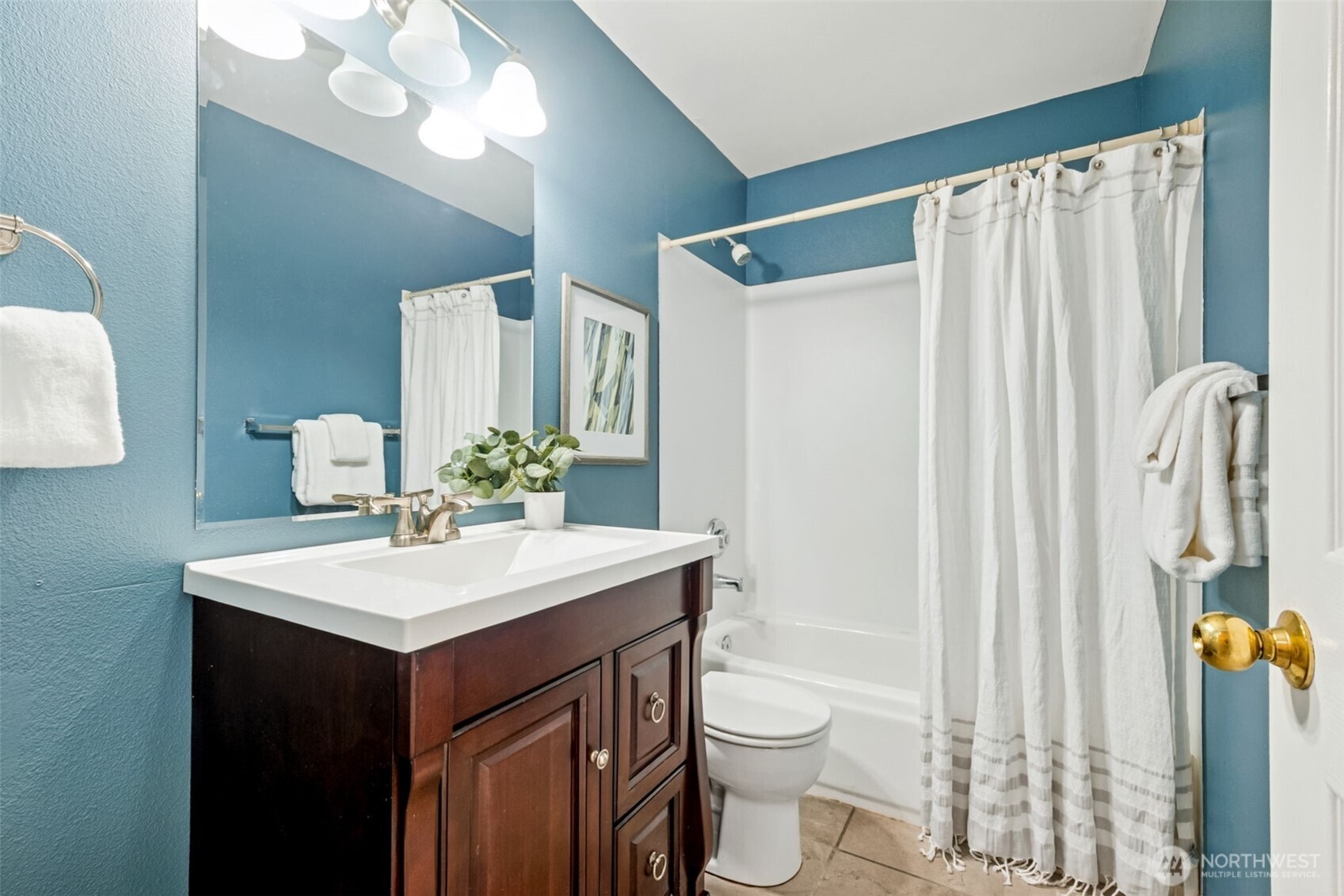 4808 Northeast Sunset Boulevard, Unit A102 Renton, WA 98059 - Photo 24 of 30 a bathroom with a sink vanity mirror and toilet