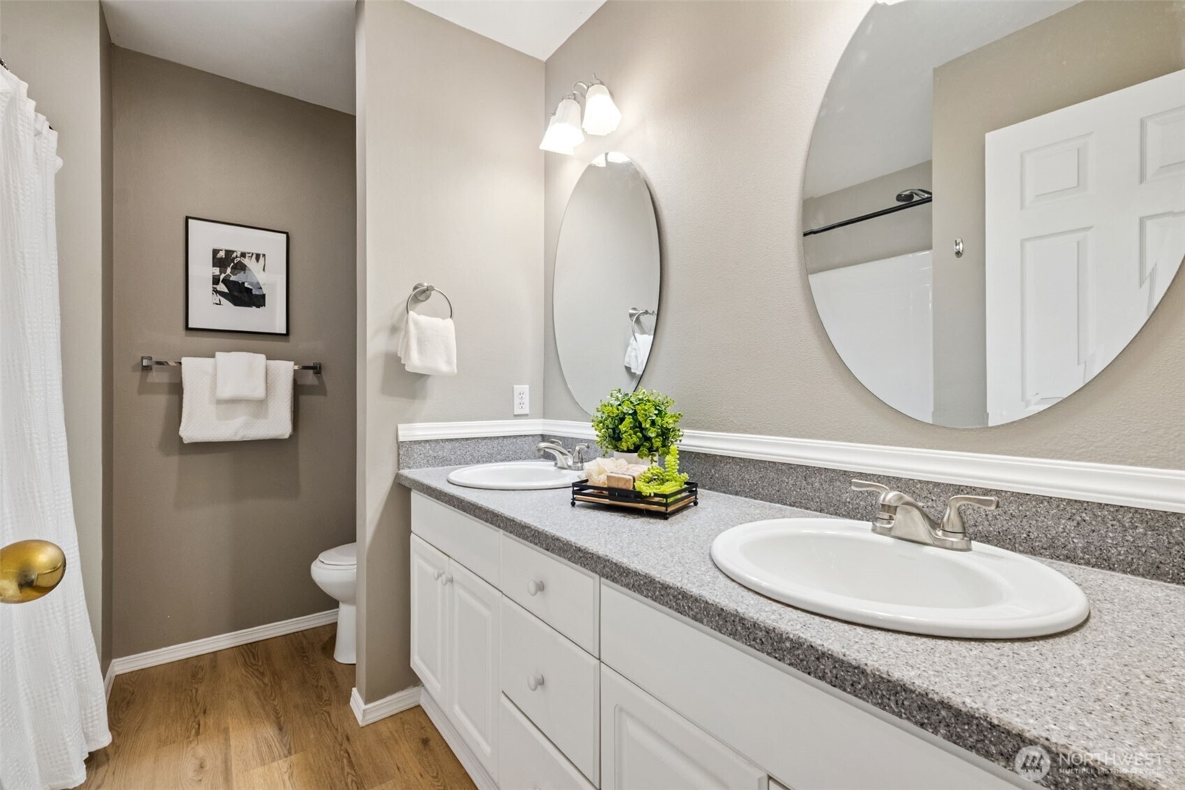 4808 Northeast Sunset Boulevard, Unit A102 Renton, WA 98059 - Photo 26 of 30 a bathroom with a double vanity sink and a mirror