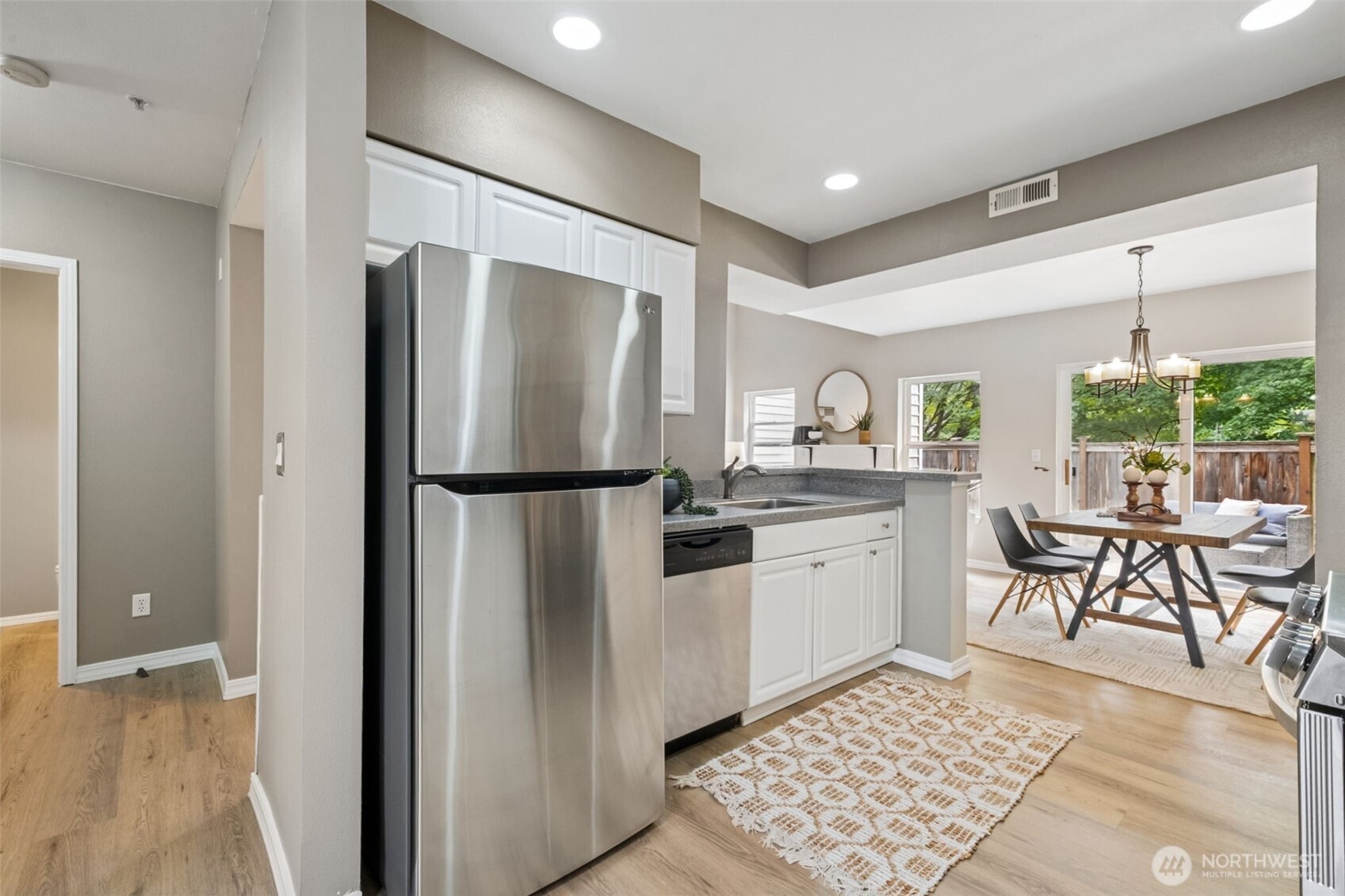 4808 Northeast Sunset Boulevard, Unit A102 Renton, WA 98059 - Photo 7 of 30 a kitchen with stainless steel appliances granite countertop a refrigerator and a sink