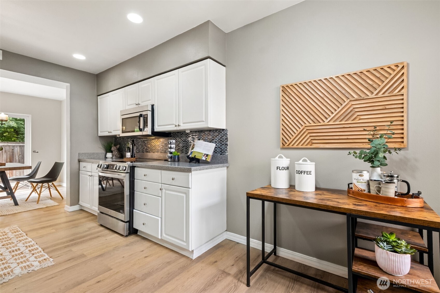 4808 Northeast Sunset Boulevard, Unit A102 Renton, WA 98059 - Photo 8 of 30 a kitchen with granite countertop cabinets stainless steel appliances a sink and a window