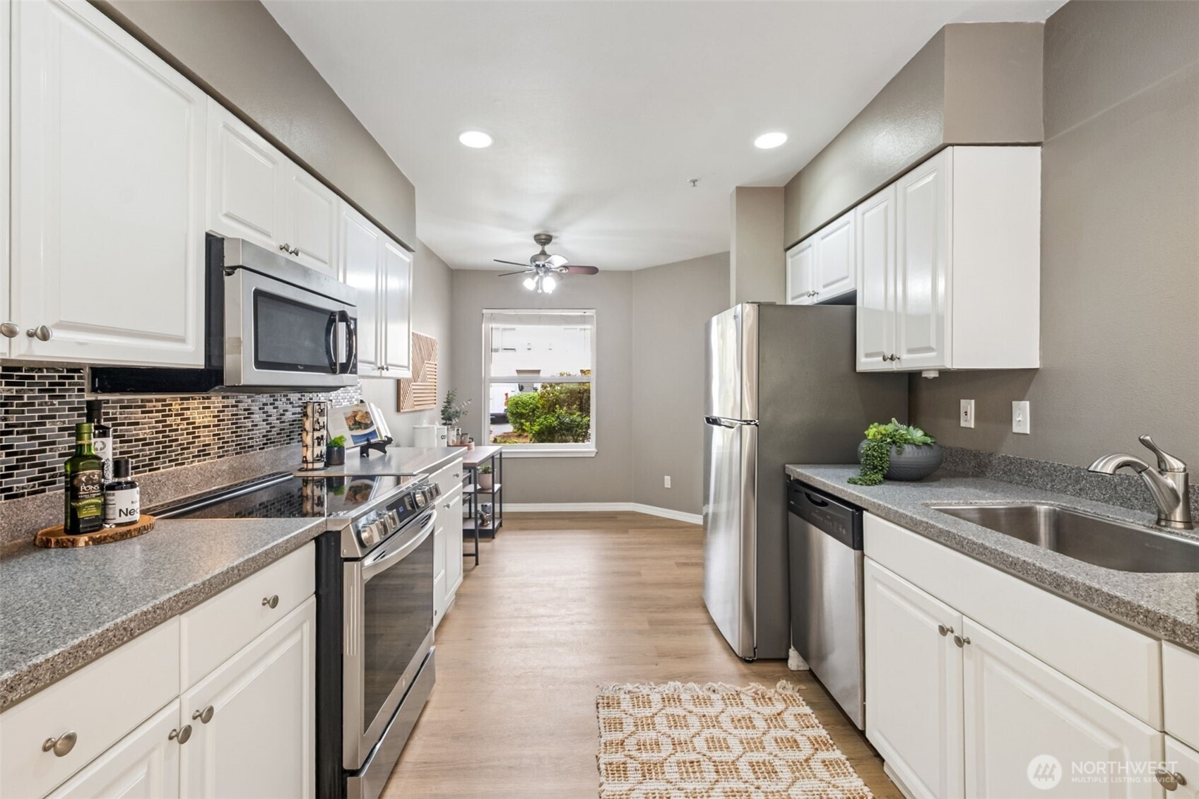 4808 Northeast Sunset Boulevard, Unit A102 Renton, WA 98059 - Photo 9 of 30 a kitchen with a sink stove and refrigerator