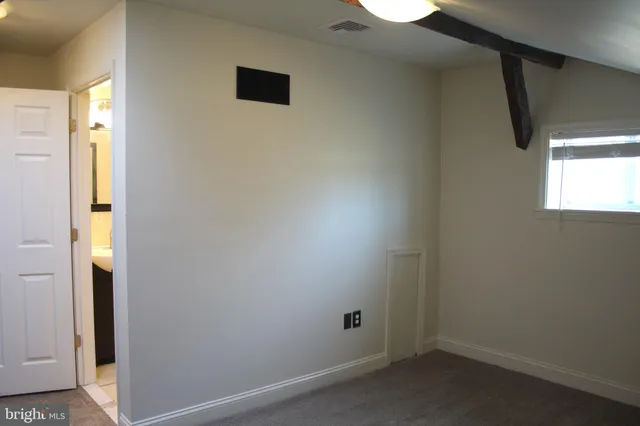 a view of storage and utility room with wooden floor