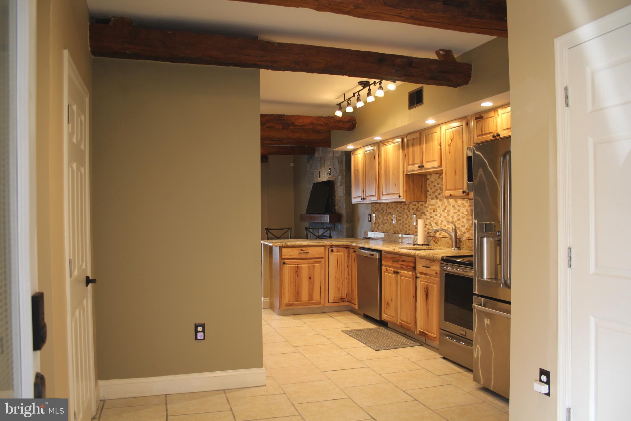 1152 South Valley Forge Road, Unit 1152 Norristown, PA 19403 - Photo 4 of 21 a kitchen with stainless steel appliances granite countertop a refrigerator and a stove top oven