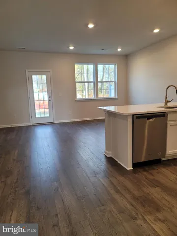 a kitchen with wooden cabinets and stainless steel appliances