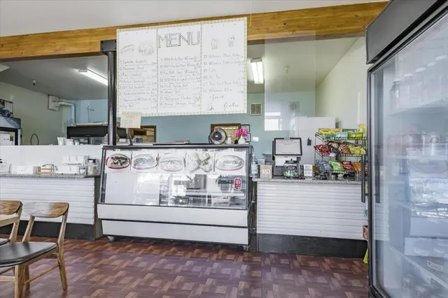 a front view of a building with sitting area