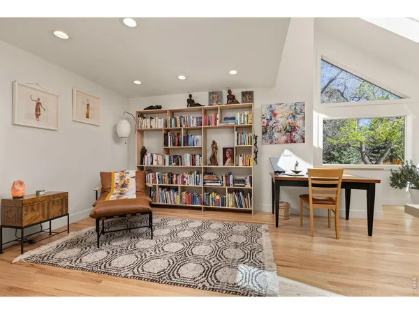 a living room with furniture and a book shelf