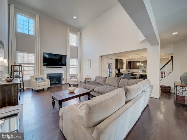 a room with lots of white furniture and a window