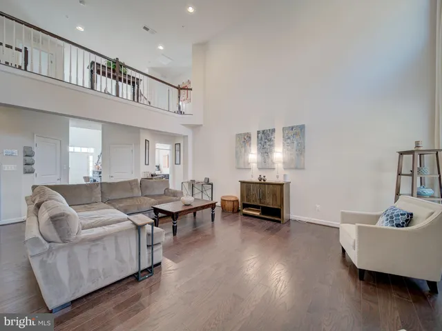 a kitchen with stainless steel appliances granite countertop a kitchen island a stove a table and chairs