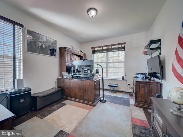 a living room with furniture a mirror and a flat screen tv