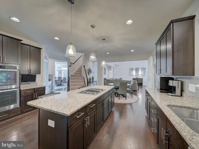 a spacious bedroom with a bed couch chandelier and a window