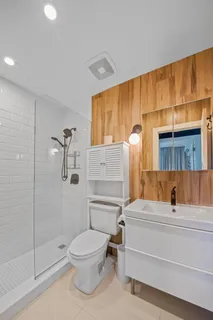 a bathroom with a toilet and a shower