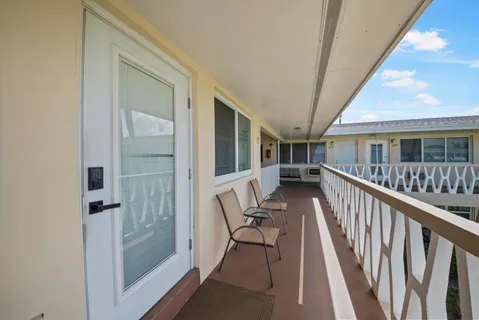 a view of balcony with wooden floor