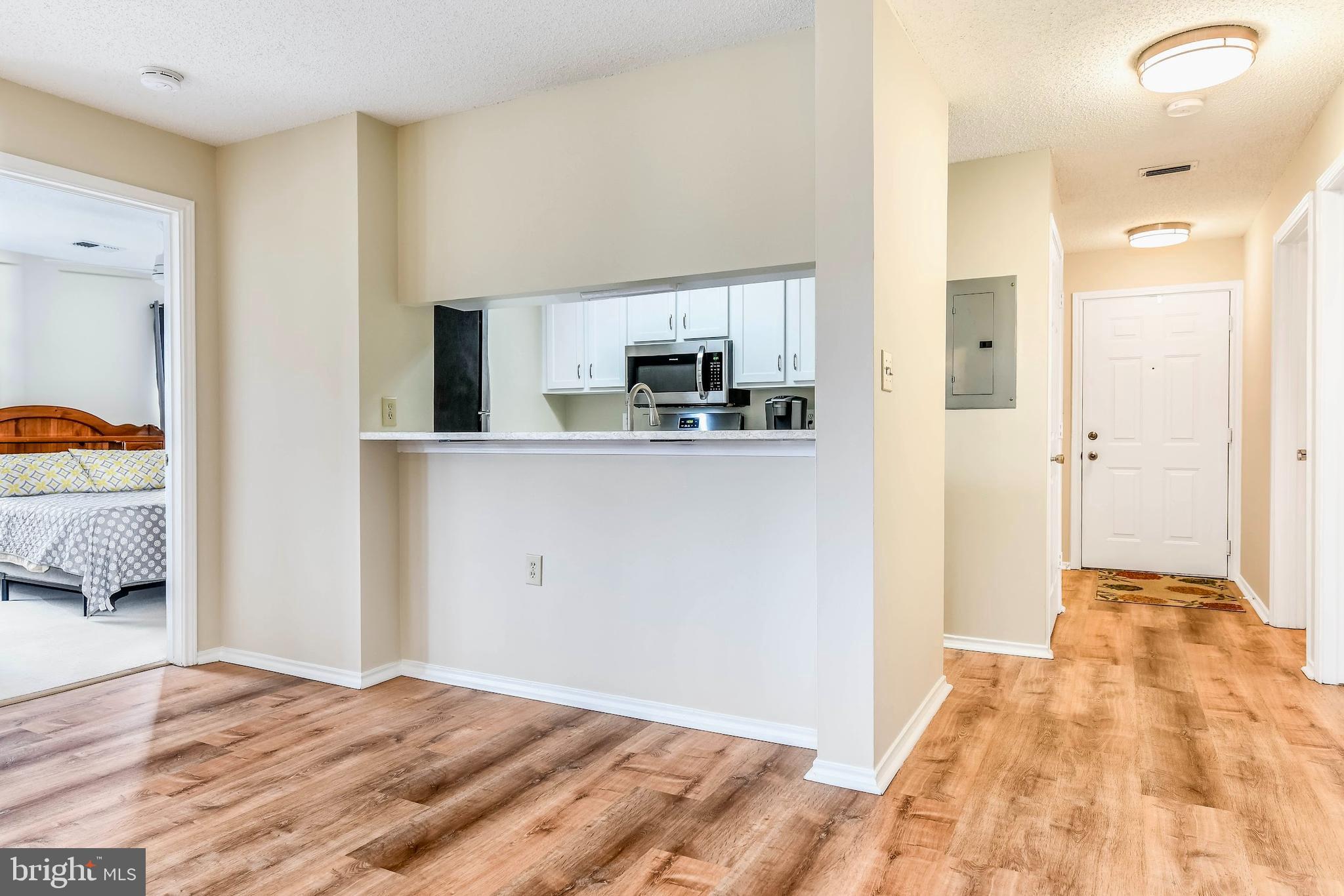 20963 Timber Ridge Terrace, Unit 302 Ashburn, VA 20147 - Photo 6 of 21 The kitchen area includes a built-in bar.