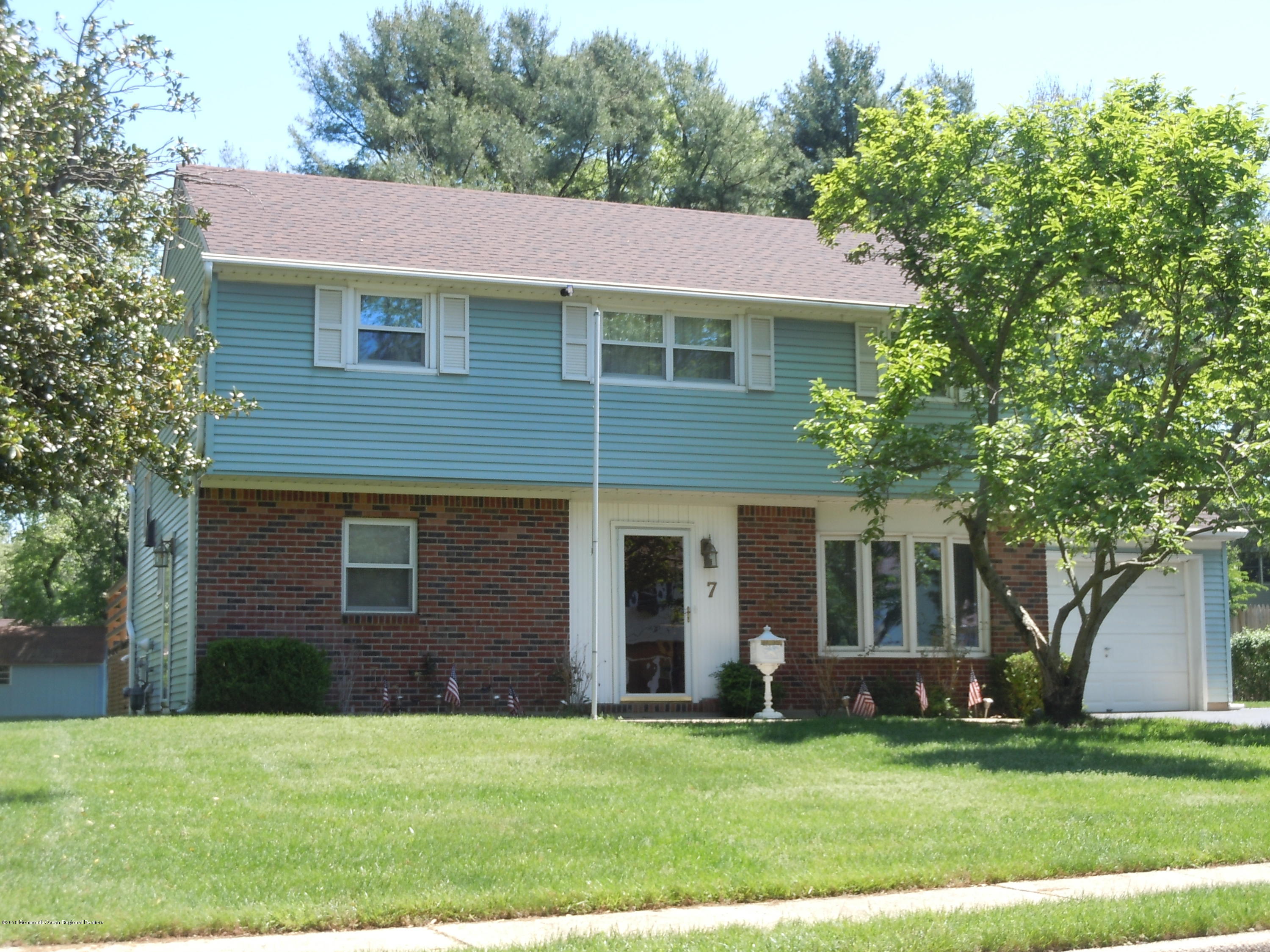 7 Peach Tree Road Oakhurst, NJ 07755 - Photo 1 of 36 a front view of a house with a yard