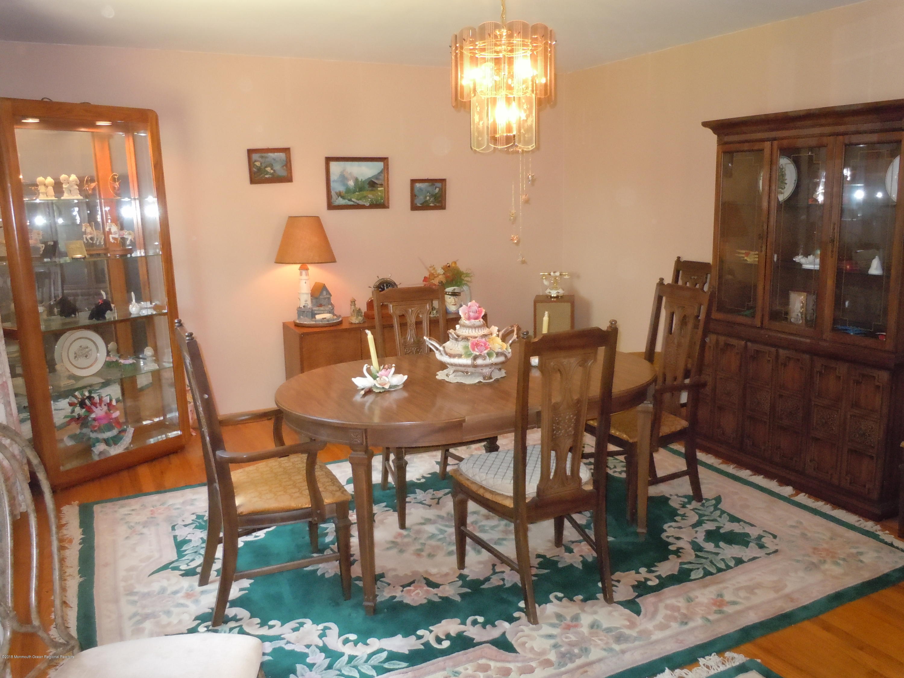 7 Peach Tree Road Oakhurst, NJ 07755 - Photo 11 of 36 a view of a dining room with furniture and chandelier