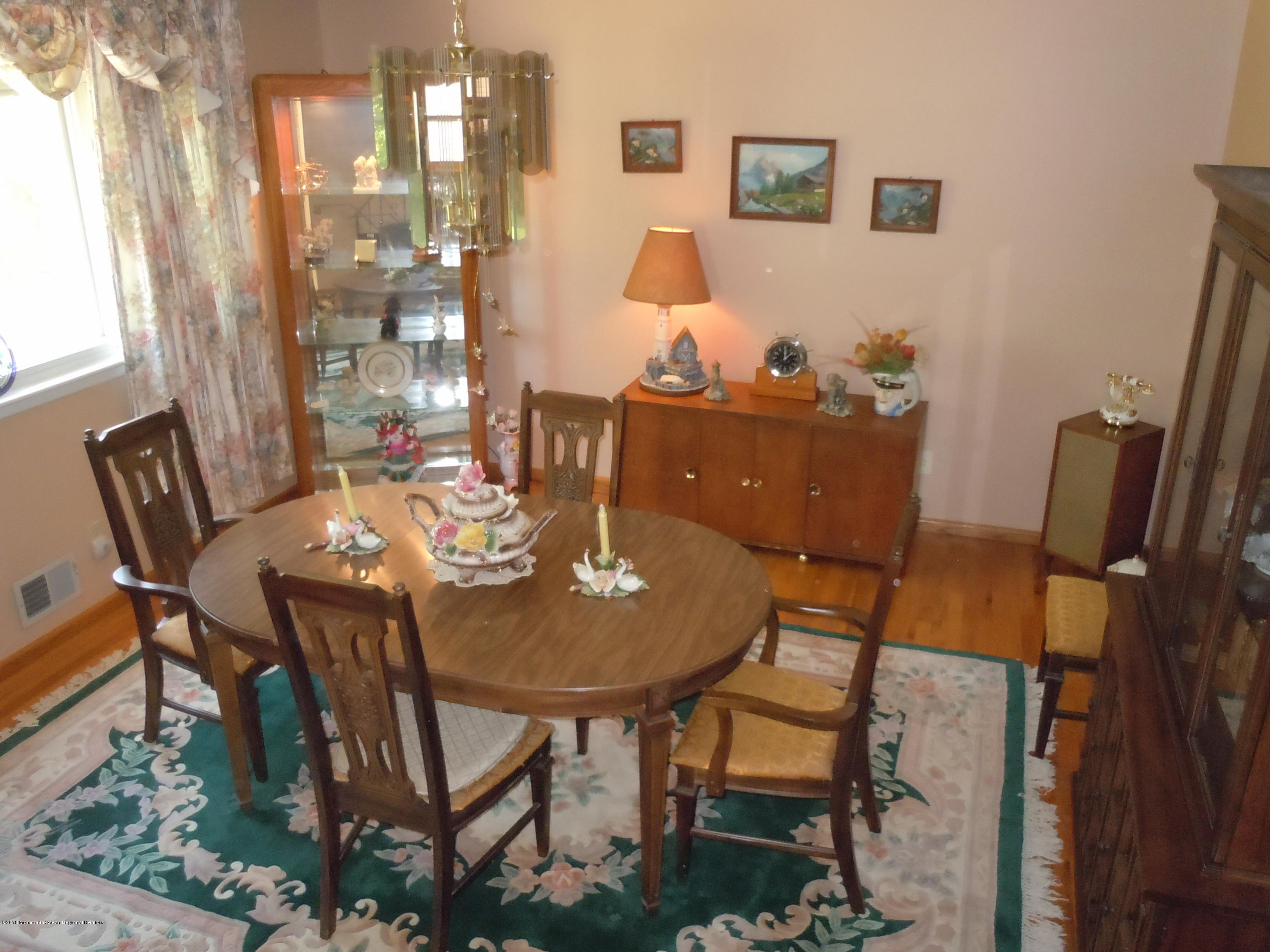 7 Peach Tree Road Oakhurst, NJ 07755 - Photo 12 of 36 a view of a dining room with furniture and wooden floor