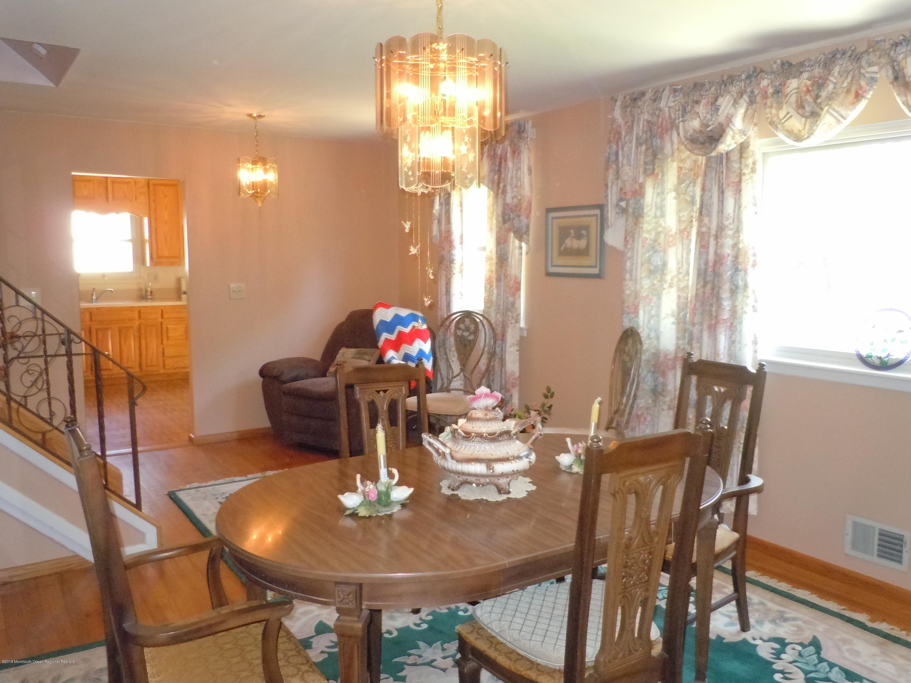 7 Peach Tree Road Oakhurst, NJ 07755 - Photo 13 of 36 a view of a dining room with furniture and chandelier