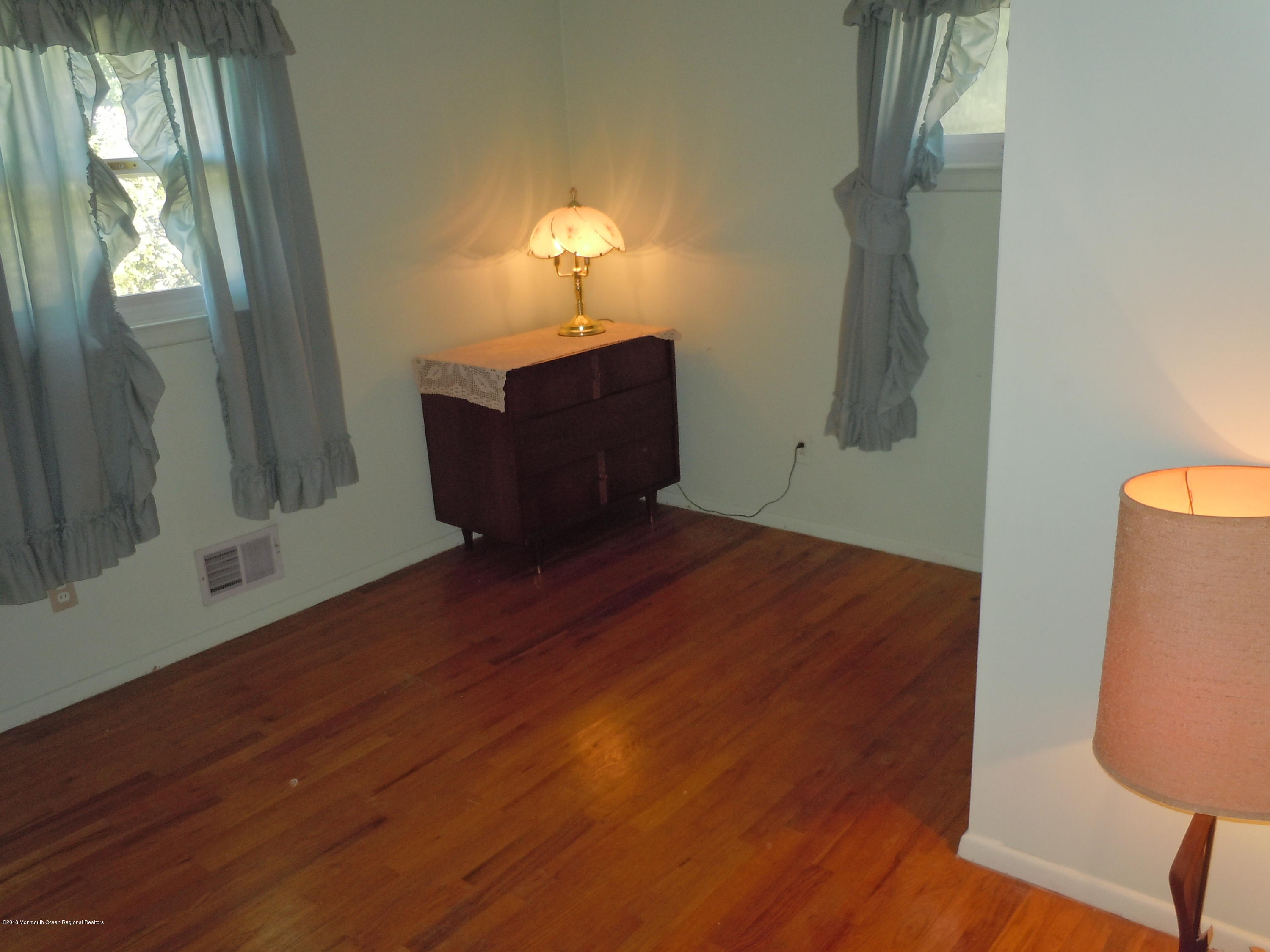 7 Peach Tree Road Oakhurst, NJ 07755 - Photo 17 of 36 a view of empty room with wooden floor and fan