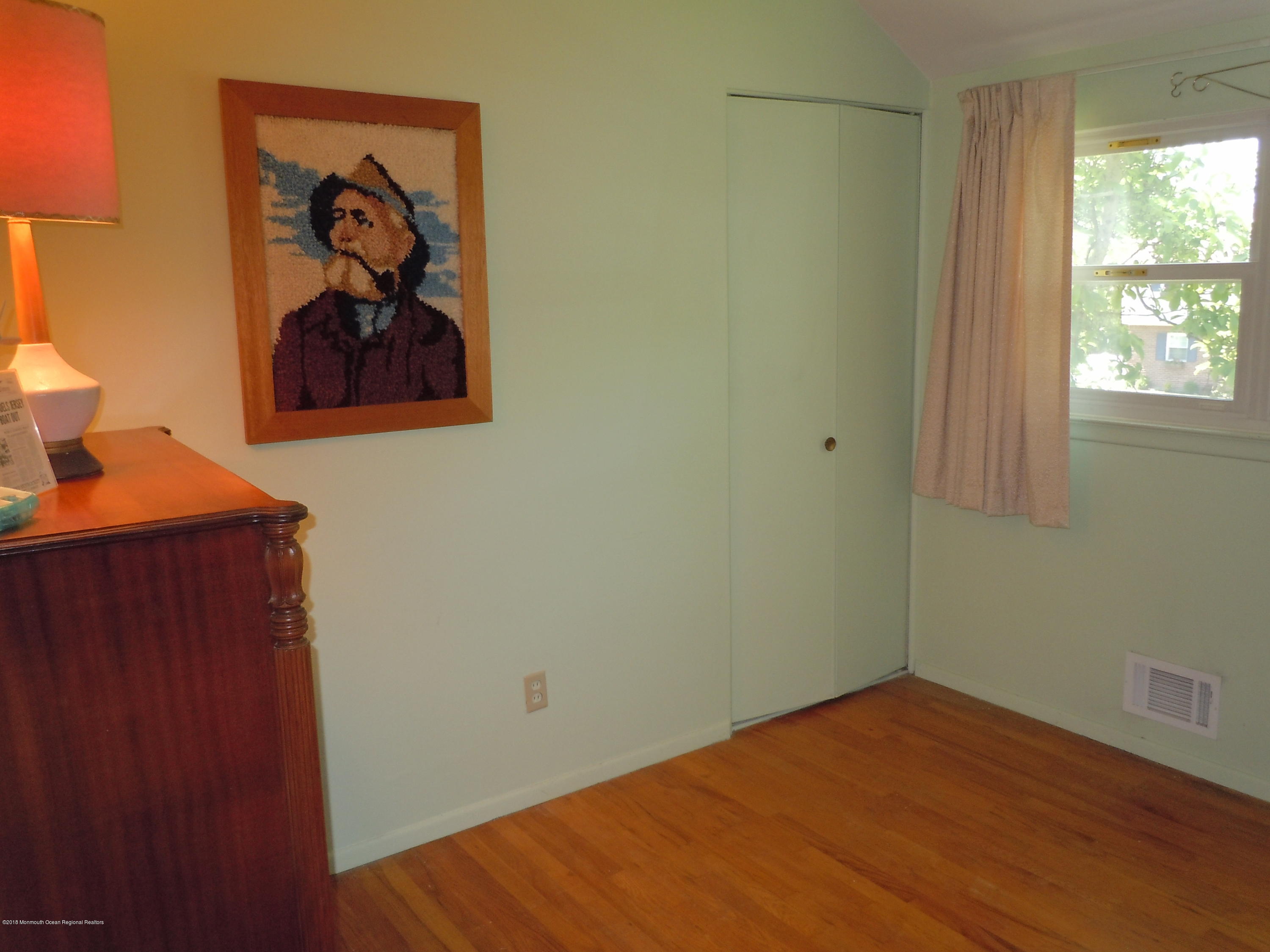 7 Peach Tree Road Oakhurst, NJ 07755 - Photo 18 of 36 a view of a hallway with wooden floor and a window