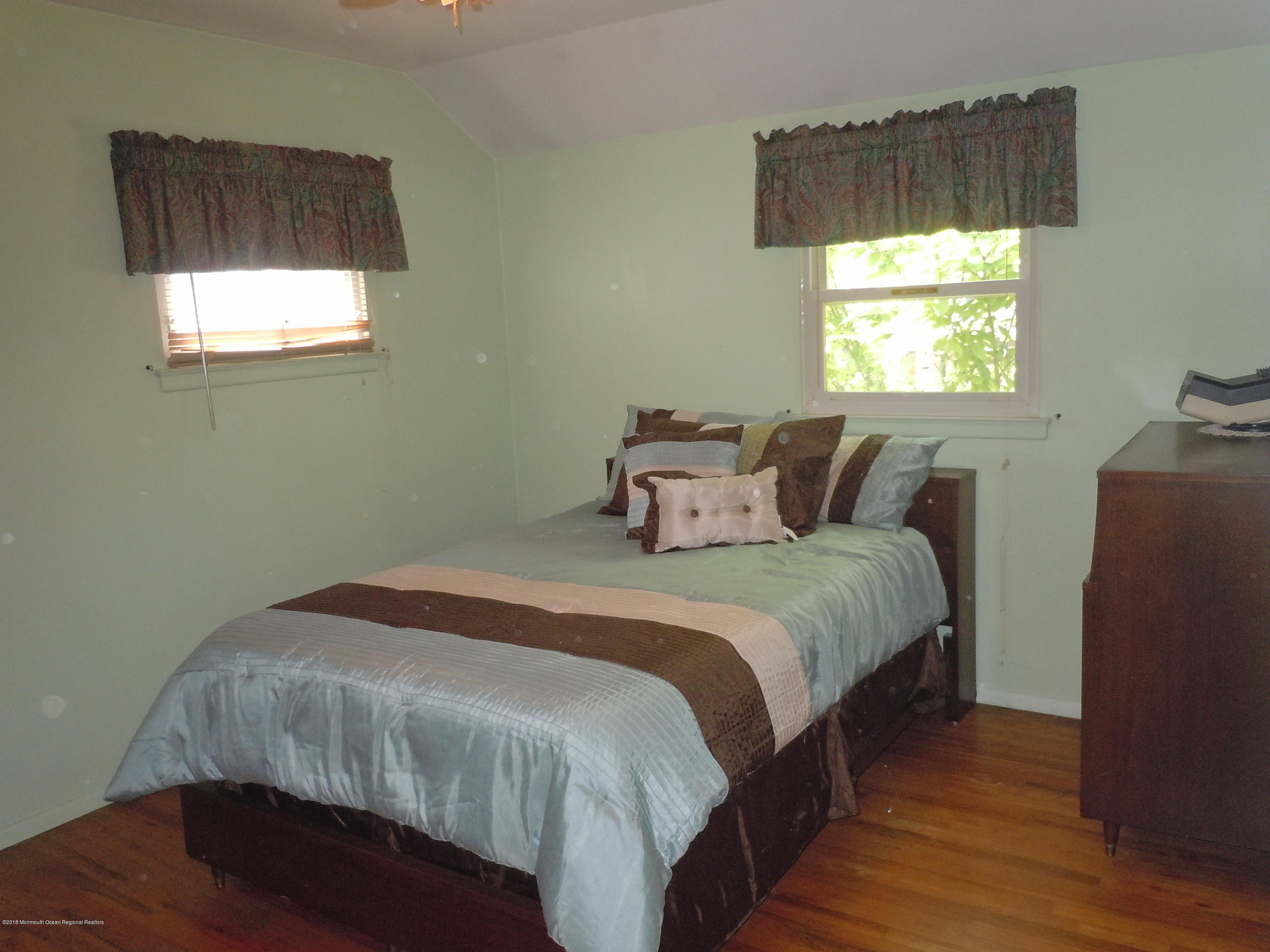 7 Peach Tree Road Oakhurst, NJ 07755 - Photo 20 of 36 a bedroom with a bed and window