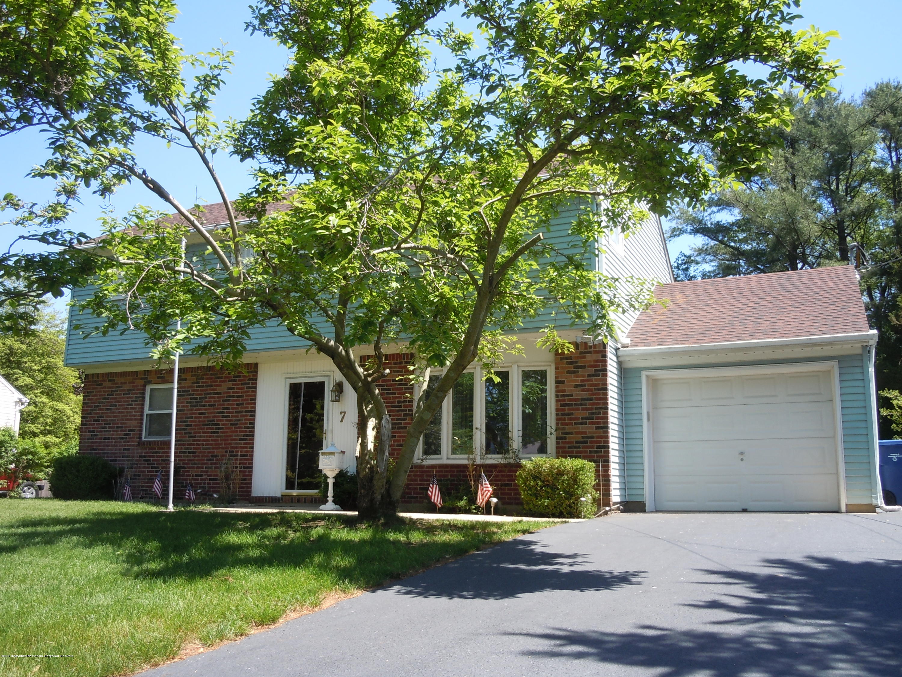 7 Peach Tree Road Oakhurst, NJ 07755 - Photo 2 of 36 front view of a house with a yard