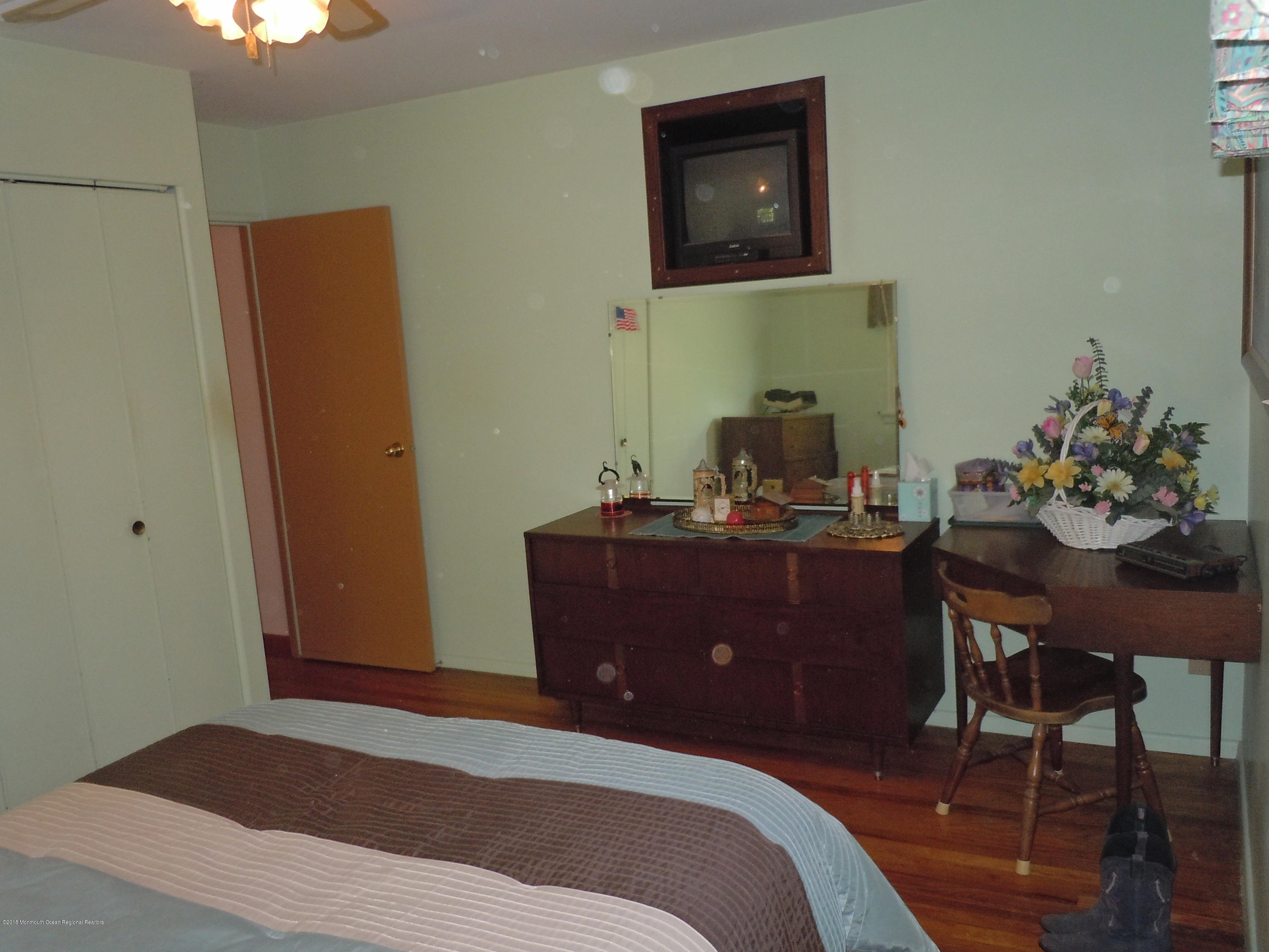 7 Peach Tree Road Oakhurst, NJ 07755 - Photo 21 of 36 a bedroom with a bed and a table