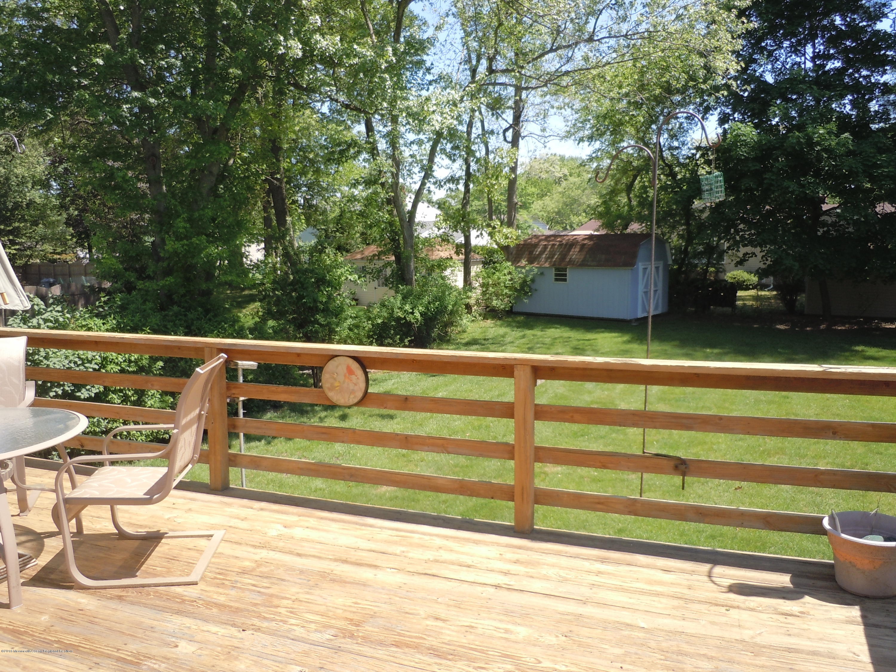 7 Peach Tree Road Oakhurst, NJ 07755 - Photo 30 of 36 a view of backyard with seating area and trees
