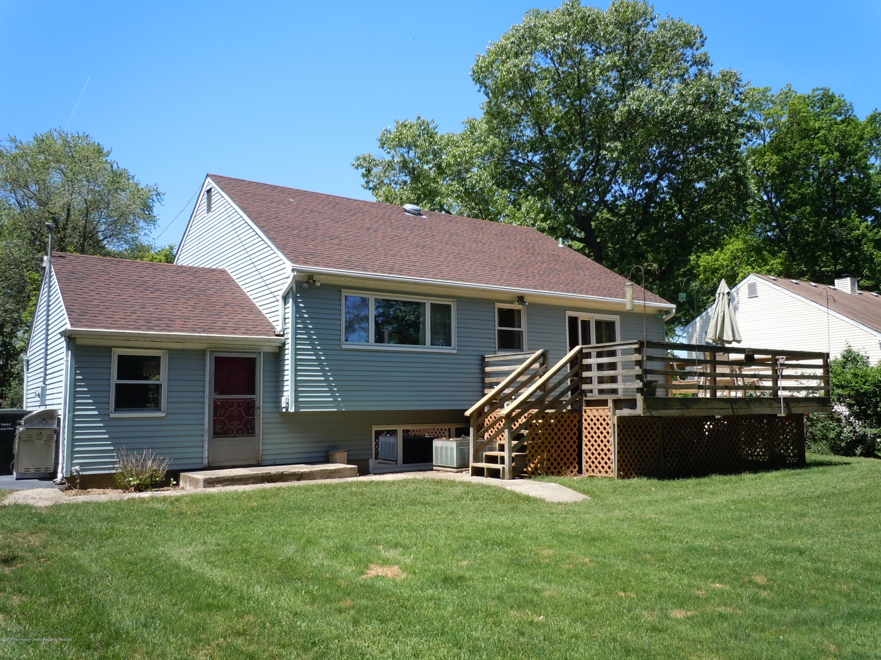 7 Peach Tree Road Oakhurst, NJ 07755 - Photo 32 of 36 a front view of a house with a garden
