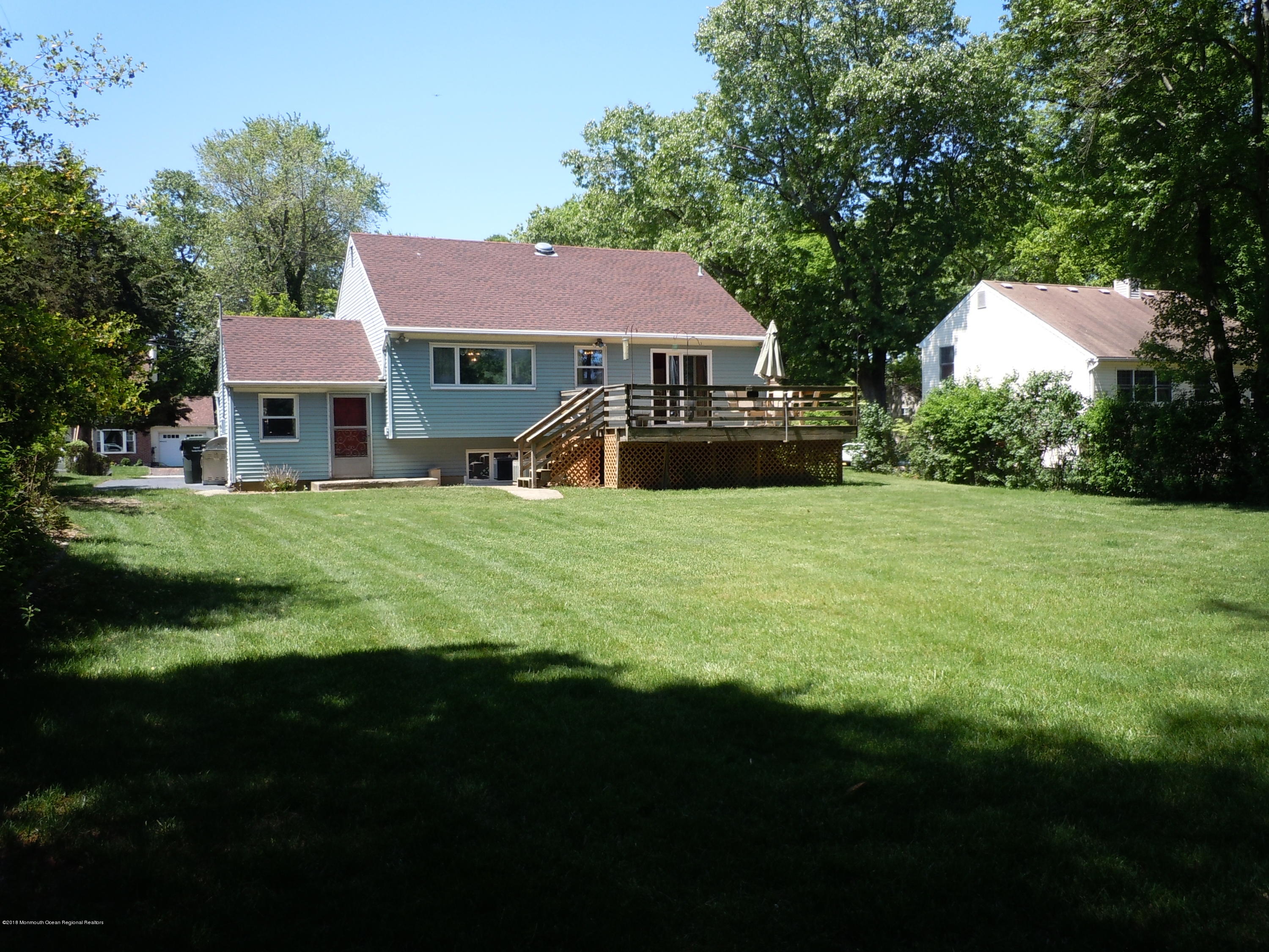 7 Peach Tree Road Oakhurst, NJ 07755 - Photo 33 of 36 a front view of a house with a garden