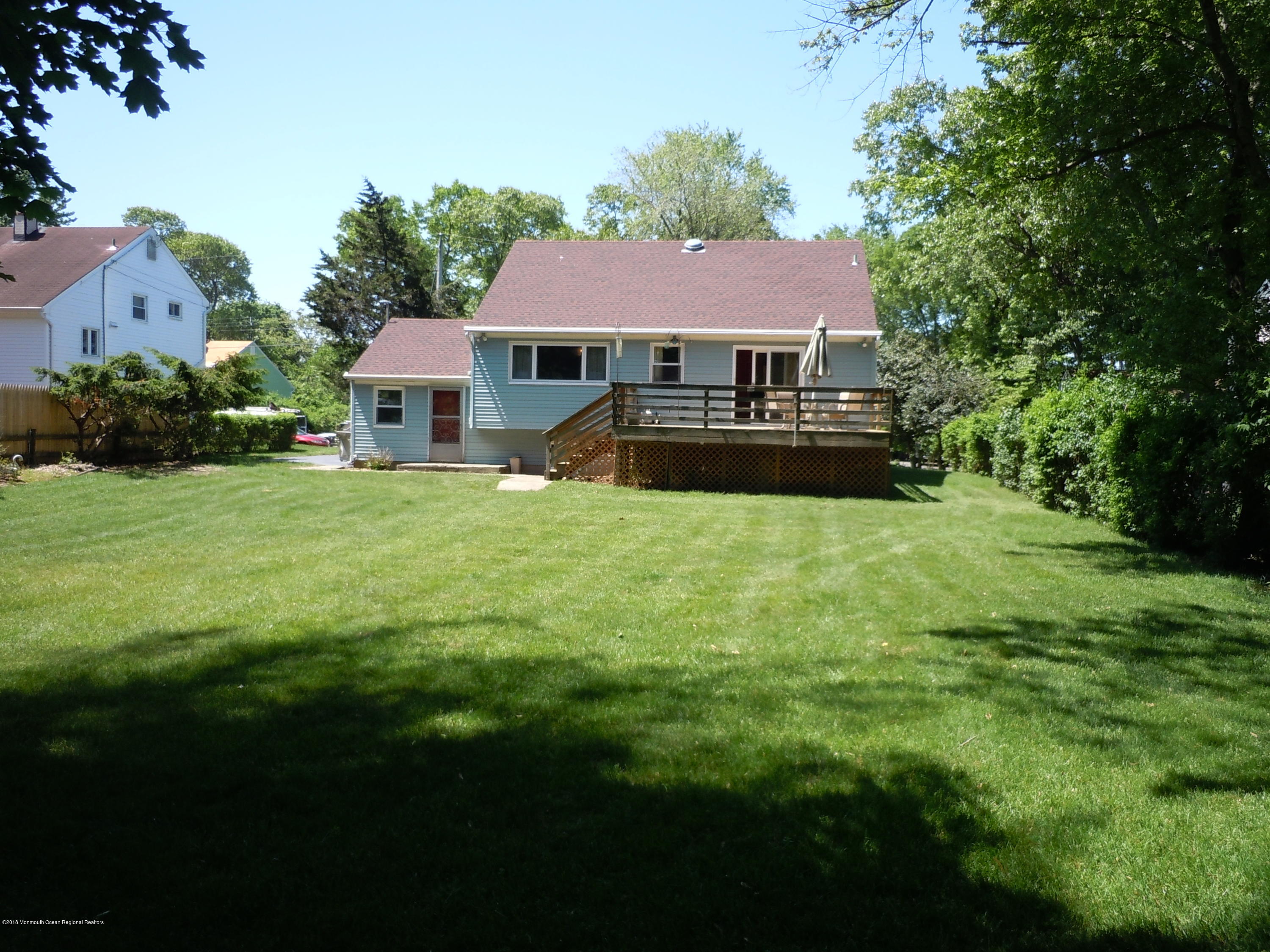 7 Peach Tree Road Oakhurst, NJ 07755 - Photo 34 of 36 a front view of a house with yard and green space