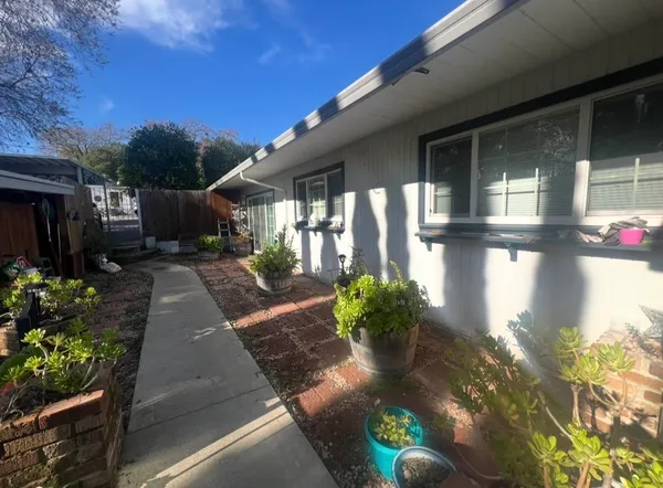 a house with flower garden in front of it